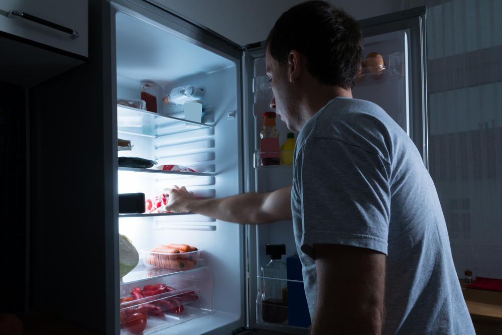 man eating from refrigerator.jpg